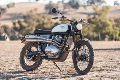 Photo of a Royal Enfield scrambler motorcycle in a paddock