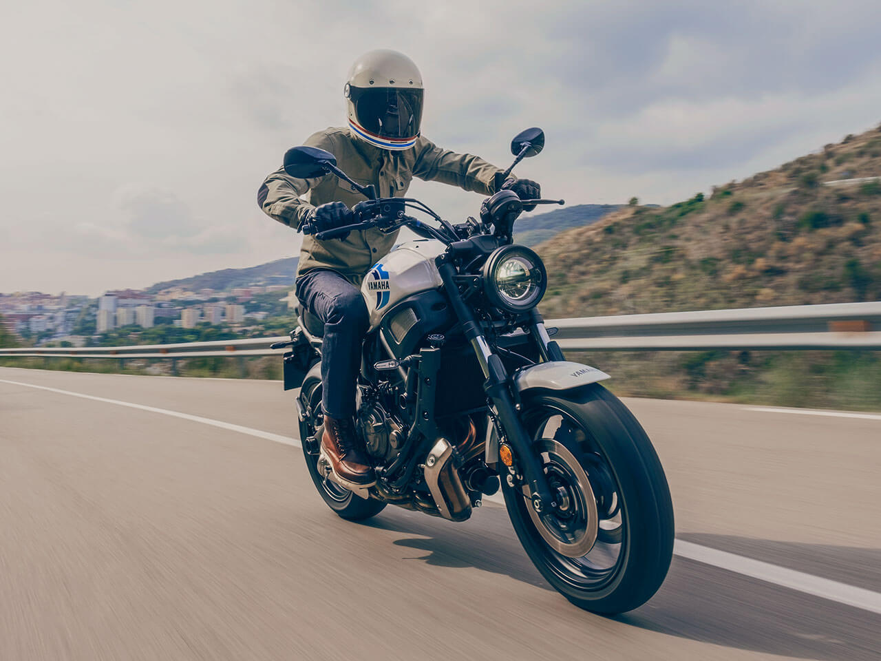 A 2020 Yamaha XSR700 motorcycle rides along a European freeway